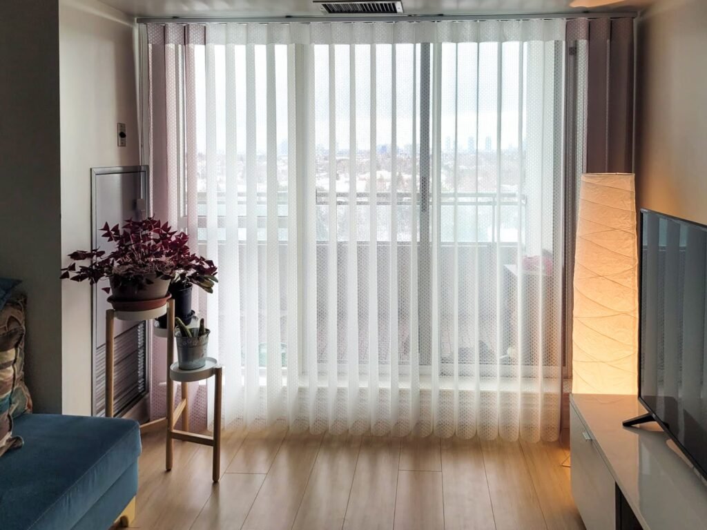 White vertical sheers on tall living room windows