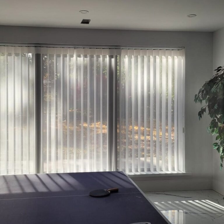 Vertical sheers on a wide window in a bedroom