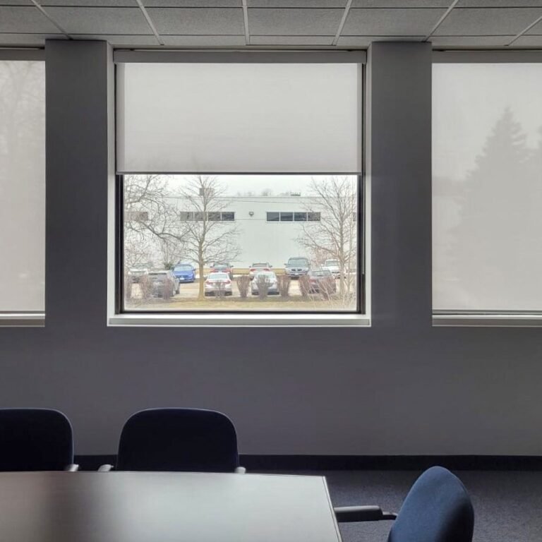 Roller shade on a window overlooking the water
