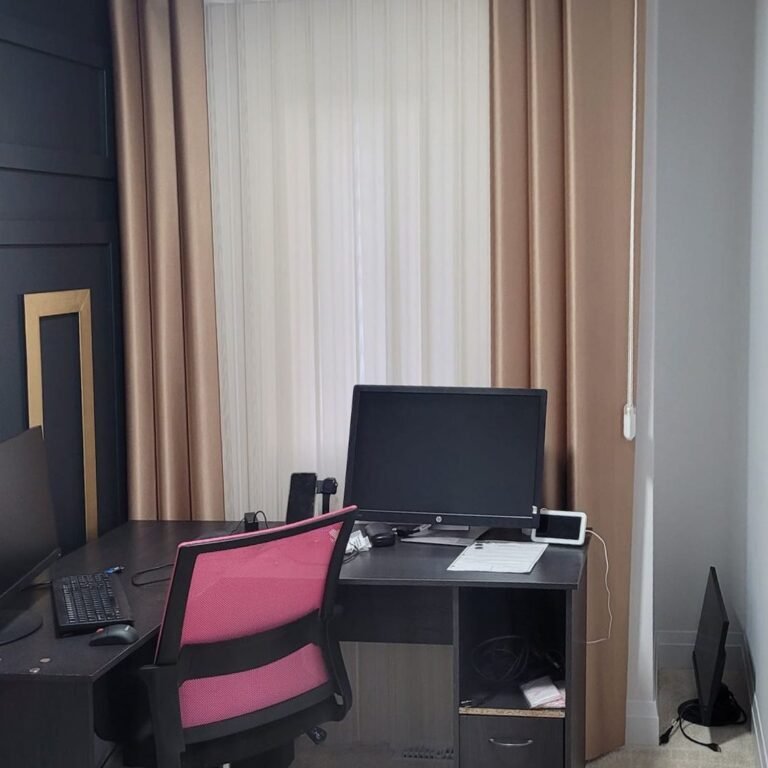 Drapery panels framing a window in a home office