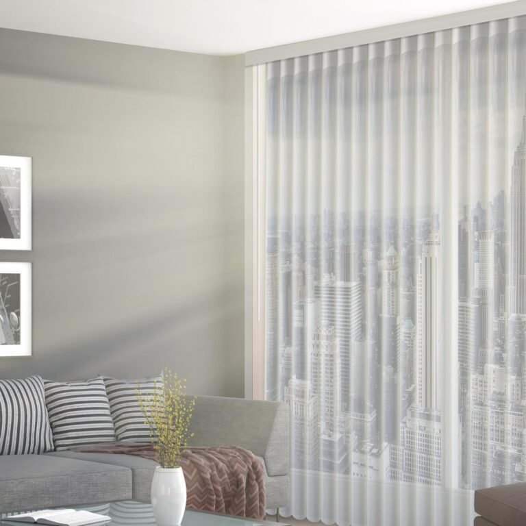 Vertical sheers in a bright living room with a grey sofa