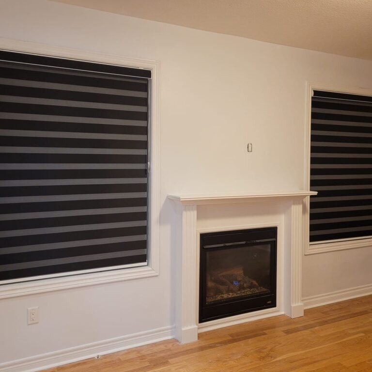 Dark room-darkening zebra blinds on windows beside a fireplace