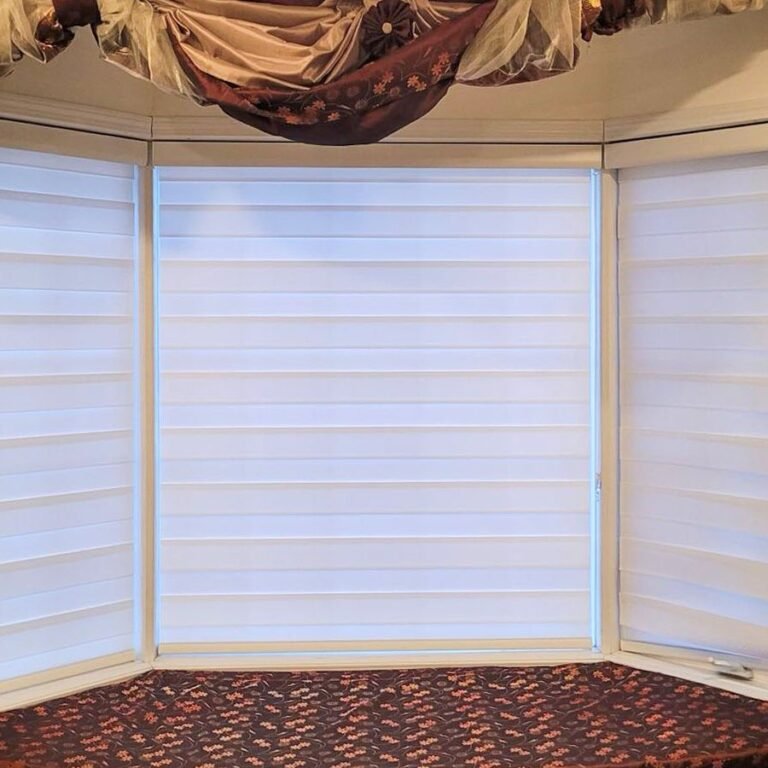 White honeycomb shades on a living room bay window