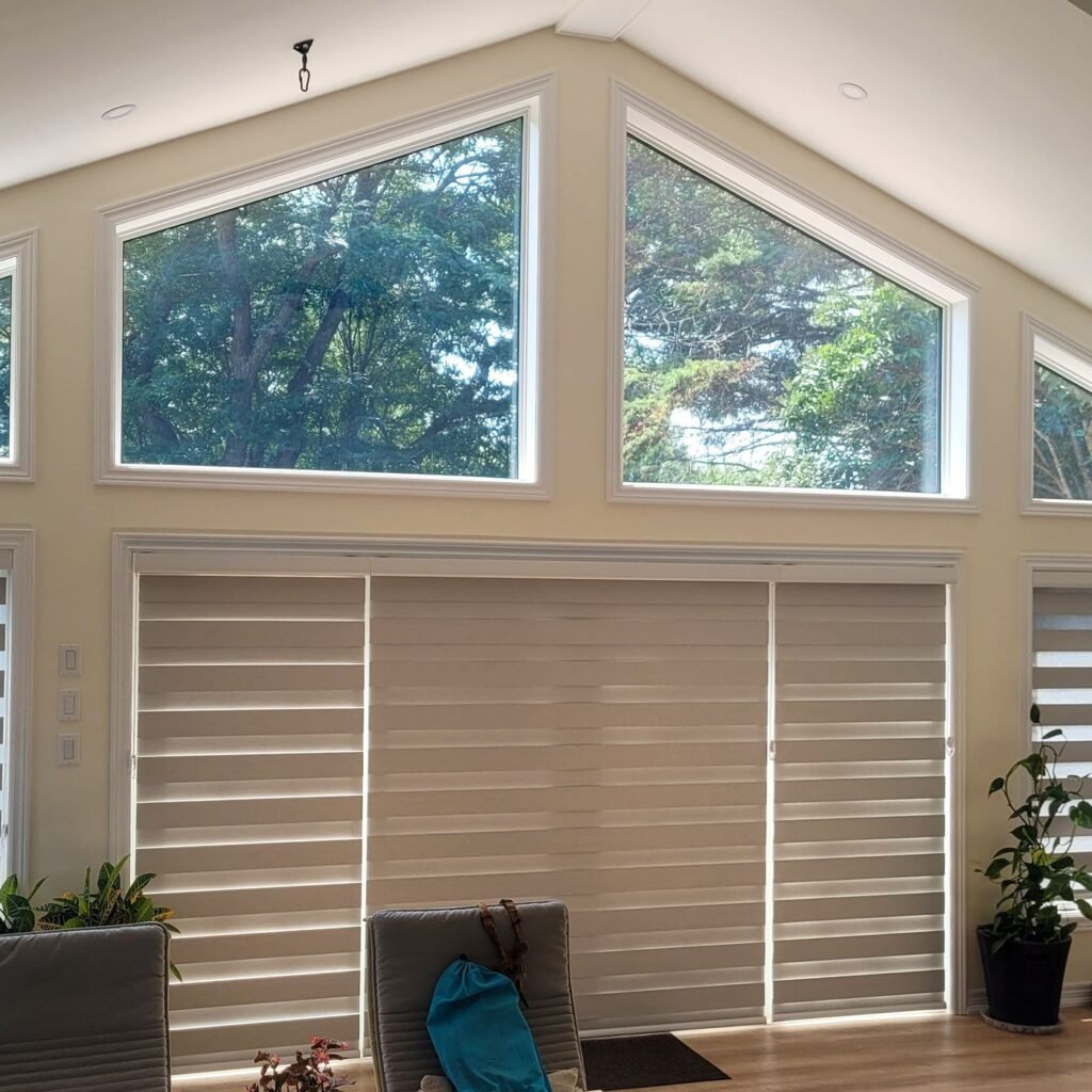 Zebra blinds on large windows below arched transom windows
