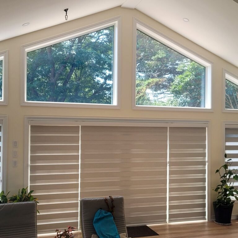 Zebra blinds on large windows below arched transom windows