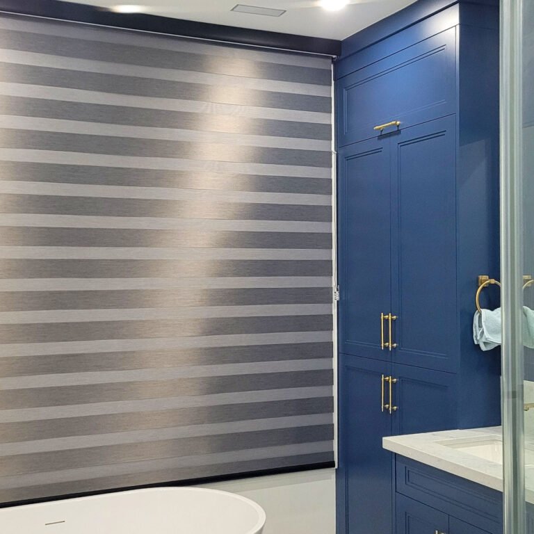 Grey shades on a bathroom window beside blue tile
