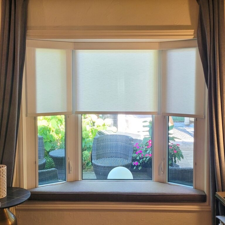 Roller shades on a three-panel bay window