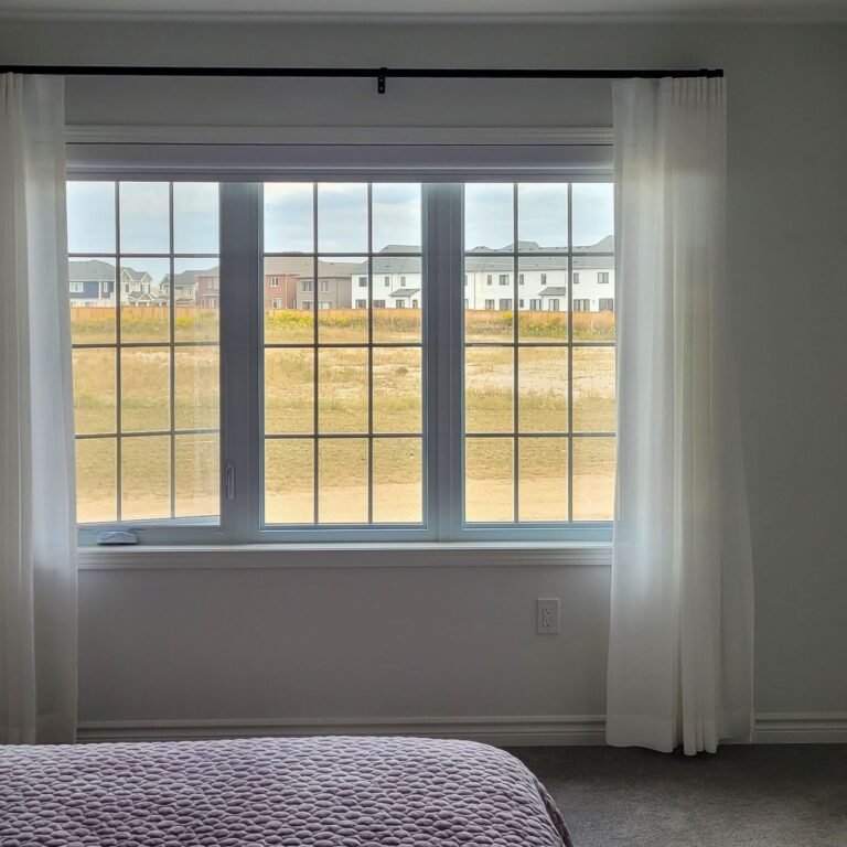 White roller shades on bedroom windows