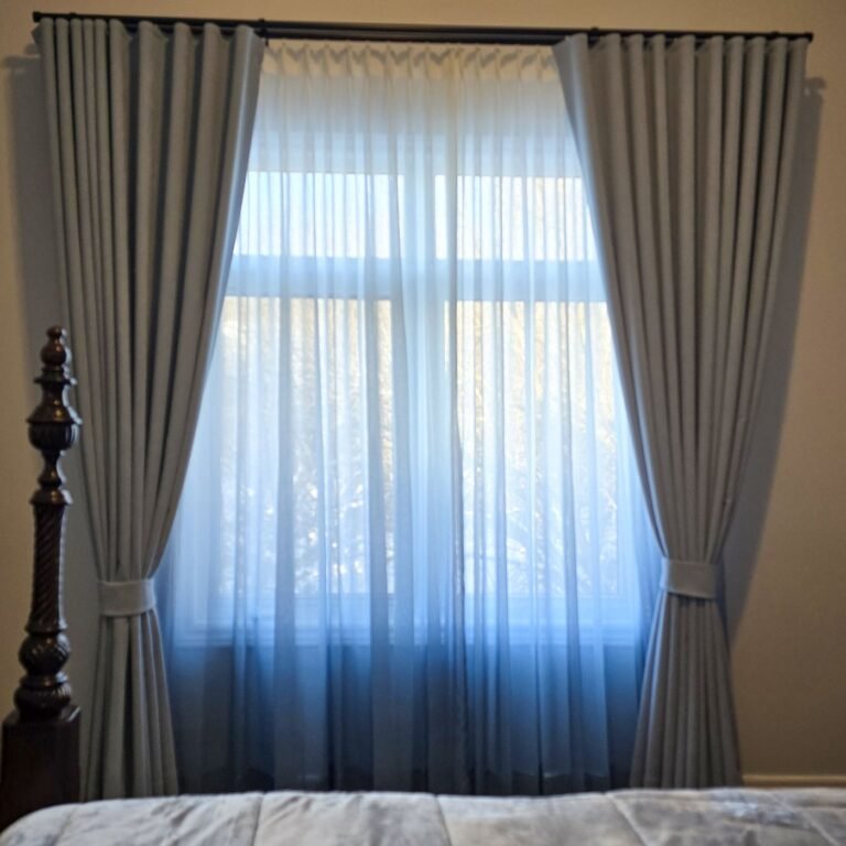Floor-length sheers with grey drapery panels in a bedroom