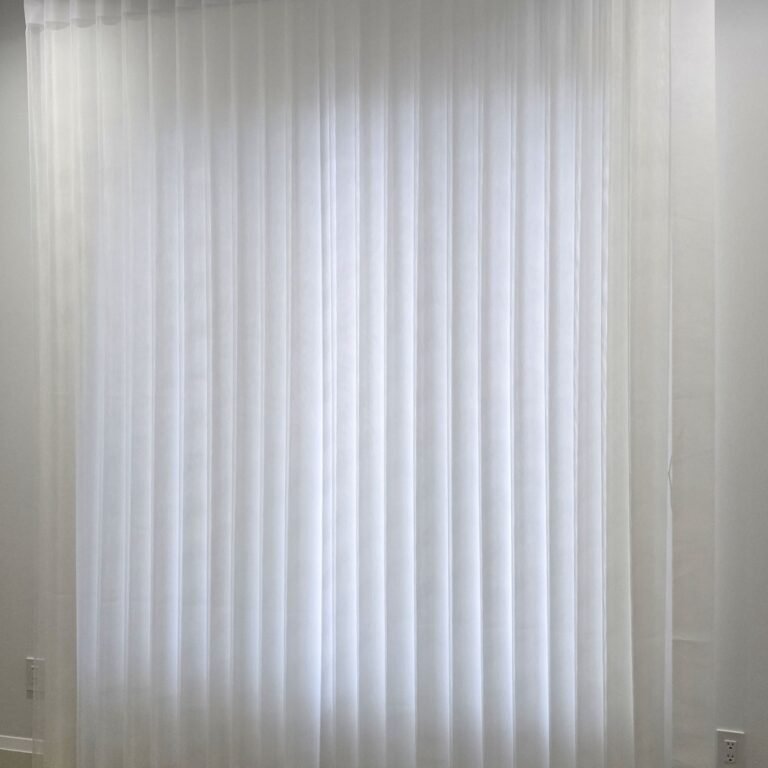Floor-to-ceiling vertical sheers on a tall window