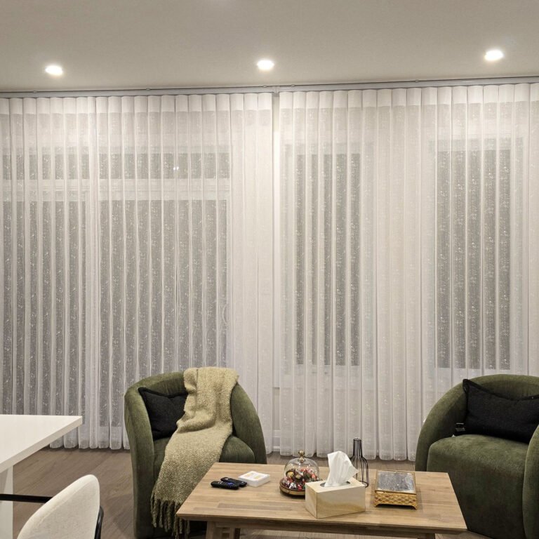 Vertical sheers across a living room window wall