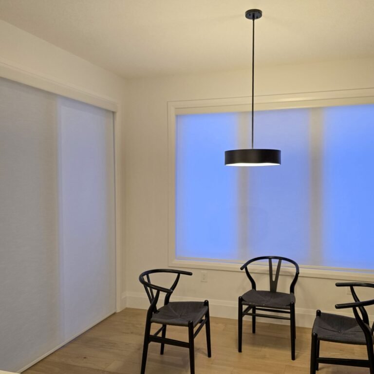 White roller shades on dining room windows