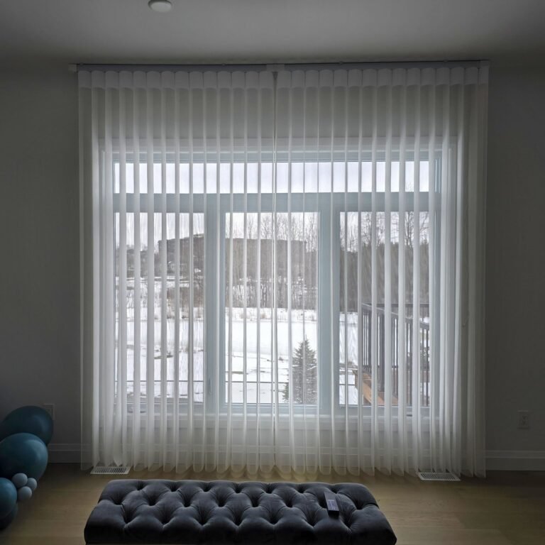Vertical sheers on patio doors behind an upholstered bench
