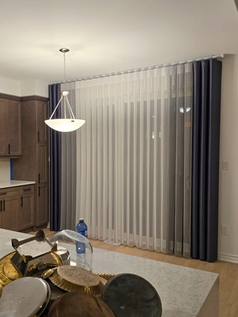 Two-tone vertical sheers on a large window in a modern living space