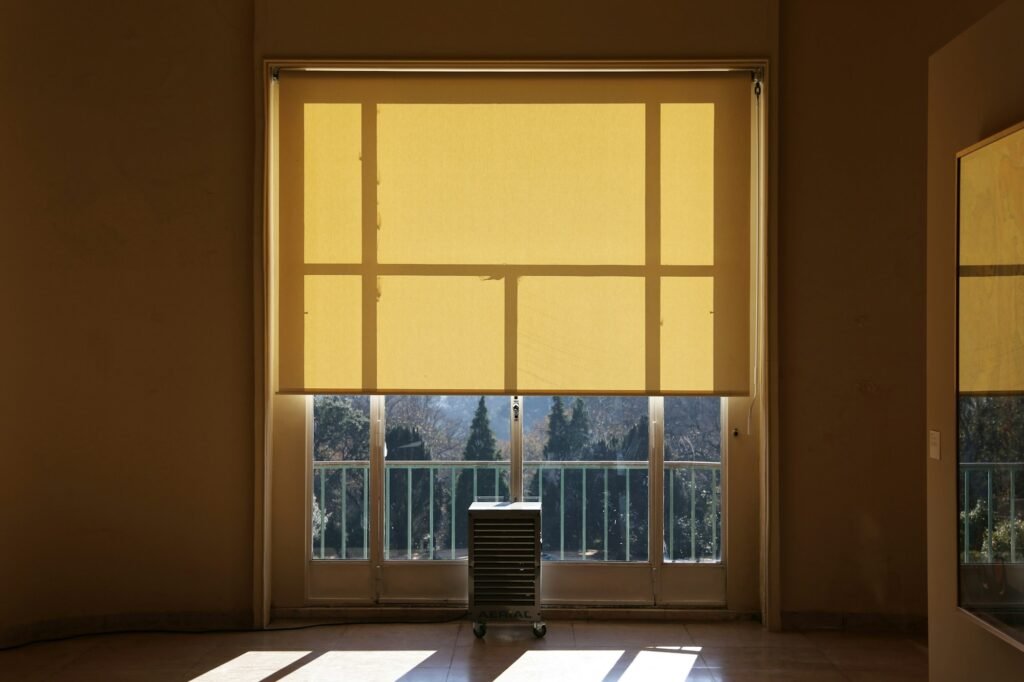 Sunlight glowing through a lowered roller shade