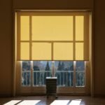Sunlight glowing through a lowered roller shade