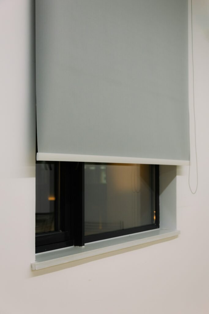 Close-up of a grey roller shade on a modern window