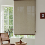 Sky light-filtering roller shade beside an armchair