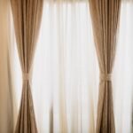 Linen drapery panels with tiebacks over sheers