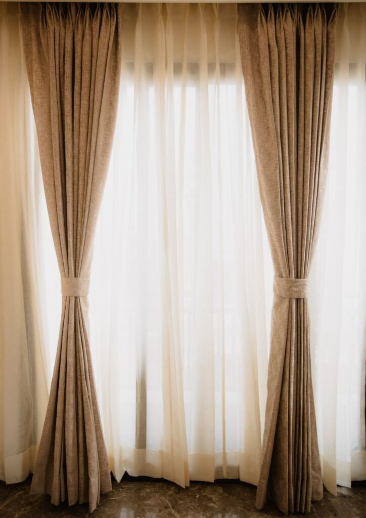 Linen drapery panels with tiebacks over sheers