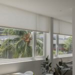 Light-filtering cellular shades across a wide window