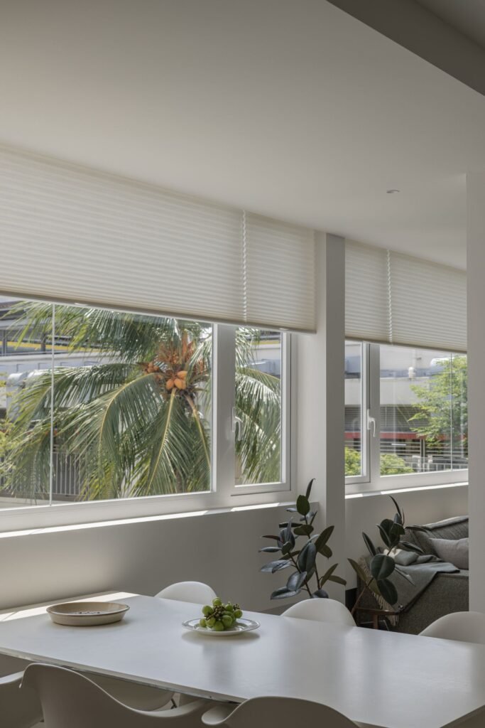 Light-filtering cellular shades across a wide window