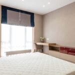 Roman shade with contrast border in a bedroom
