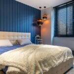 Room-darkening blinds in a navy bedroom