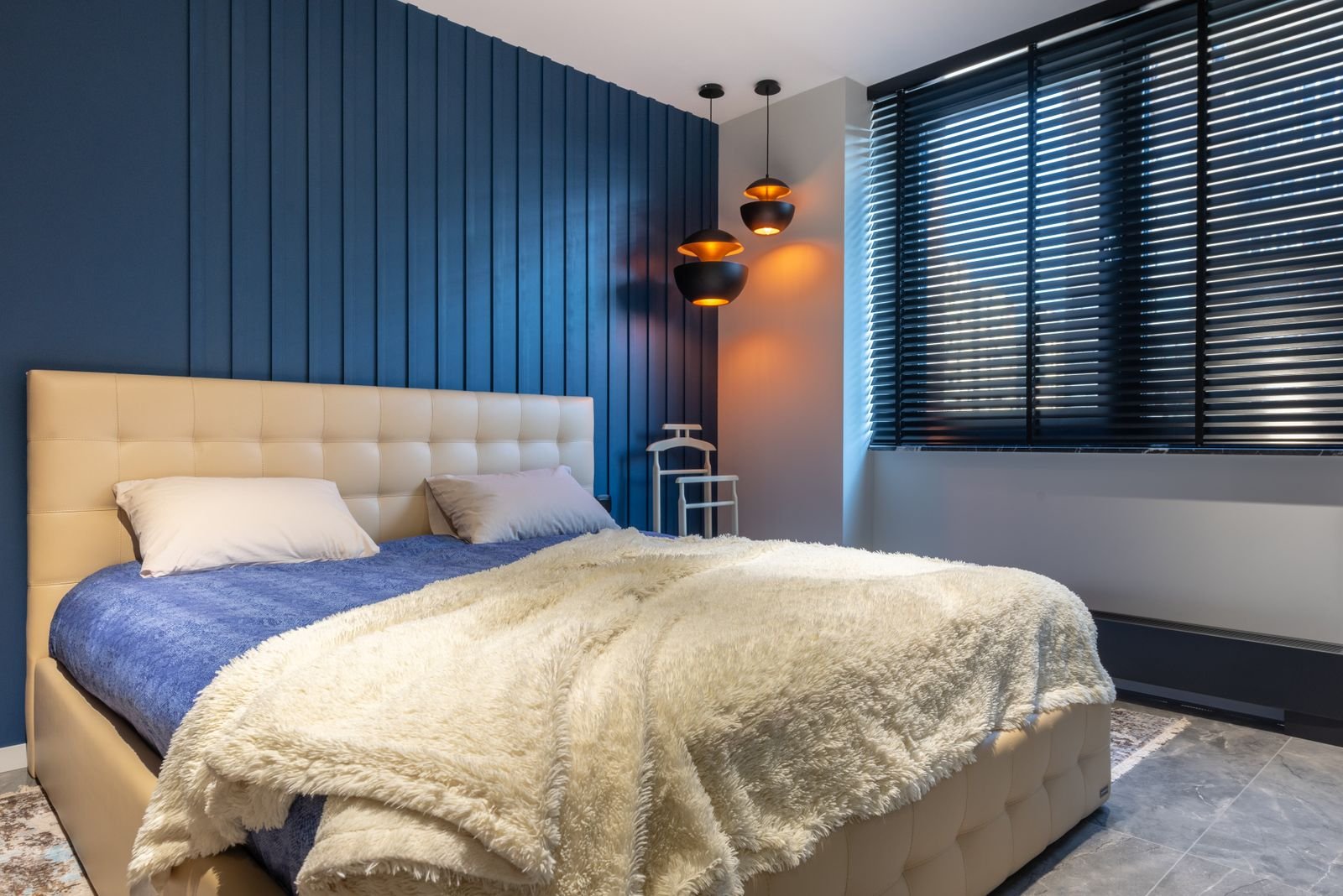 Room-darkening blinds in a navy bedroom