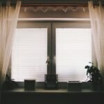 Cellular shades layered with sheer curtains