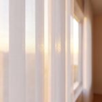 Close-up of vertical sheer vanes filtering daylight
