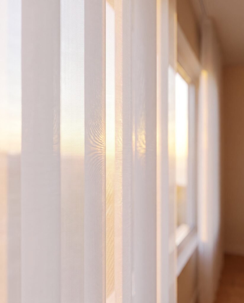 Close-up of vertical sheer vanes filtering daylight